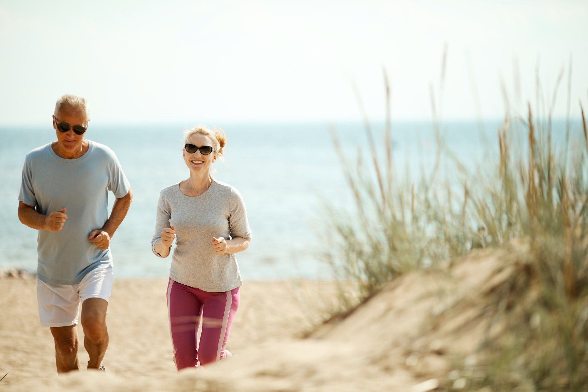 Seniors jogging while discussing Medicare Advantage and original medicare.