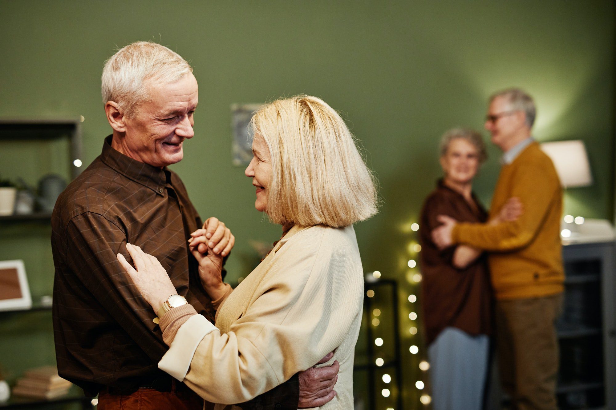 Senior man and woman dancing as they discuss the reason for medicare premium increase due to new Alzheimers drug.
