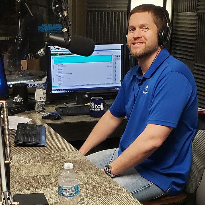 Justin Colvin behind the mic doing a the Medicare Podcast